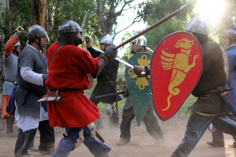 a group of men in medieval dress and helmets with swordes