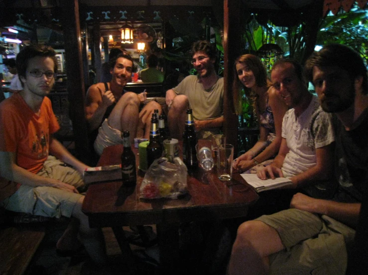 several people are sitting together at a table