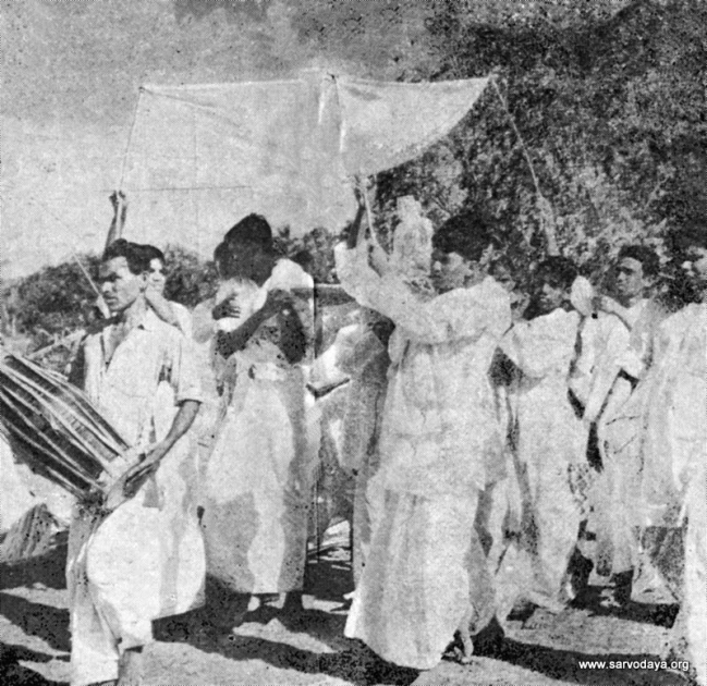 the group of people walk away from a tent