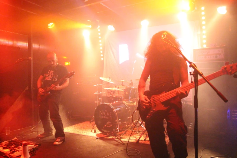 a band playing in the darkness on stage