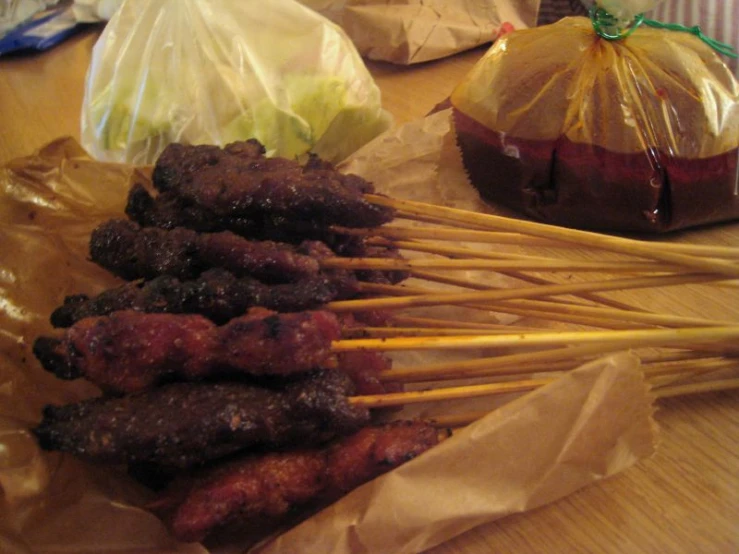 a close up of food sitting on sticks