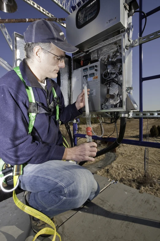 man in hard hat is fixing and preparing an electrical device