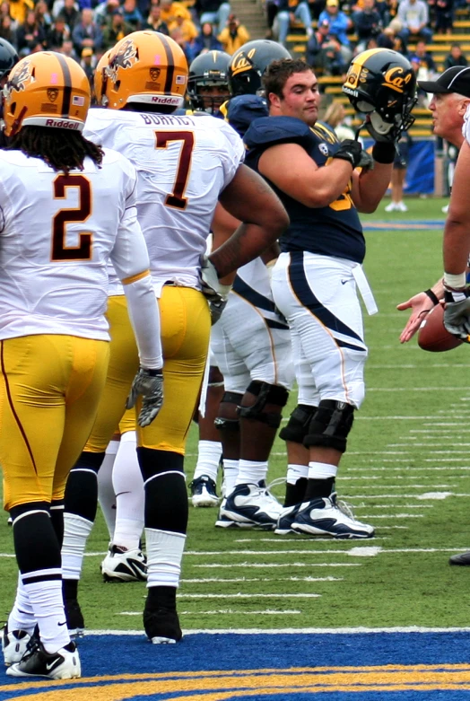 the football players are warming up before a game