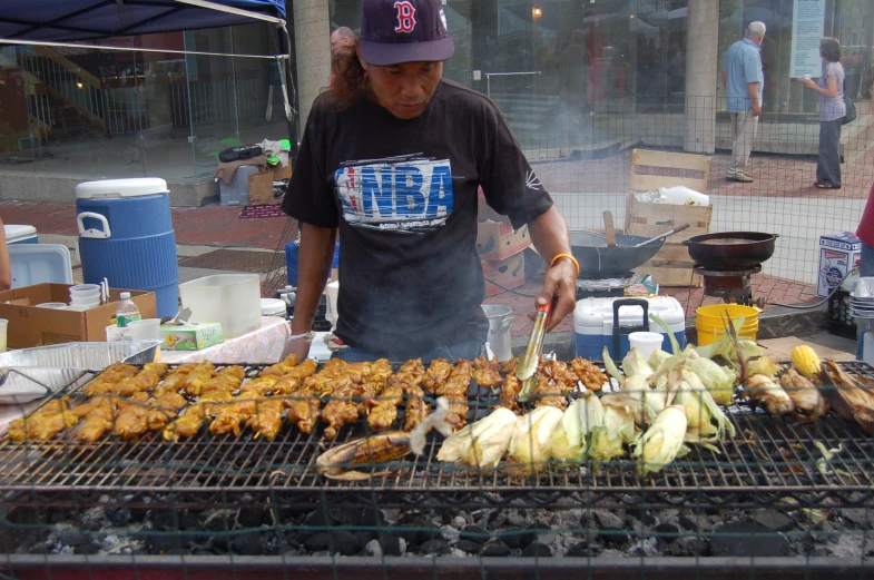 a man cooking some food on a grill