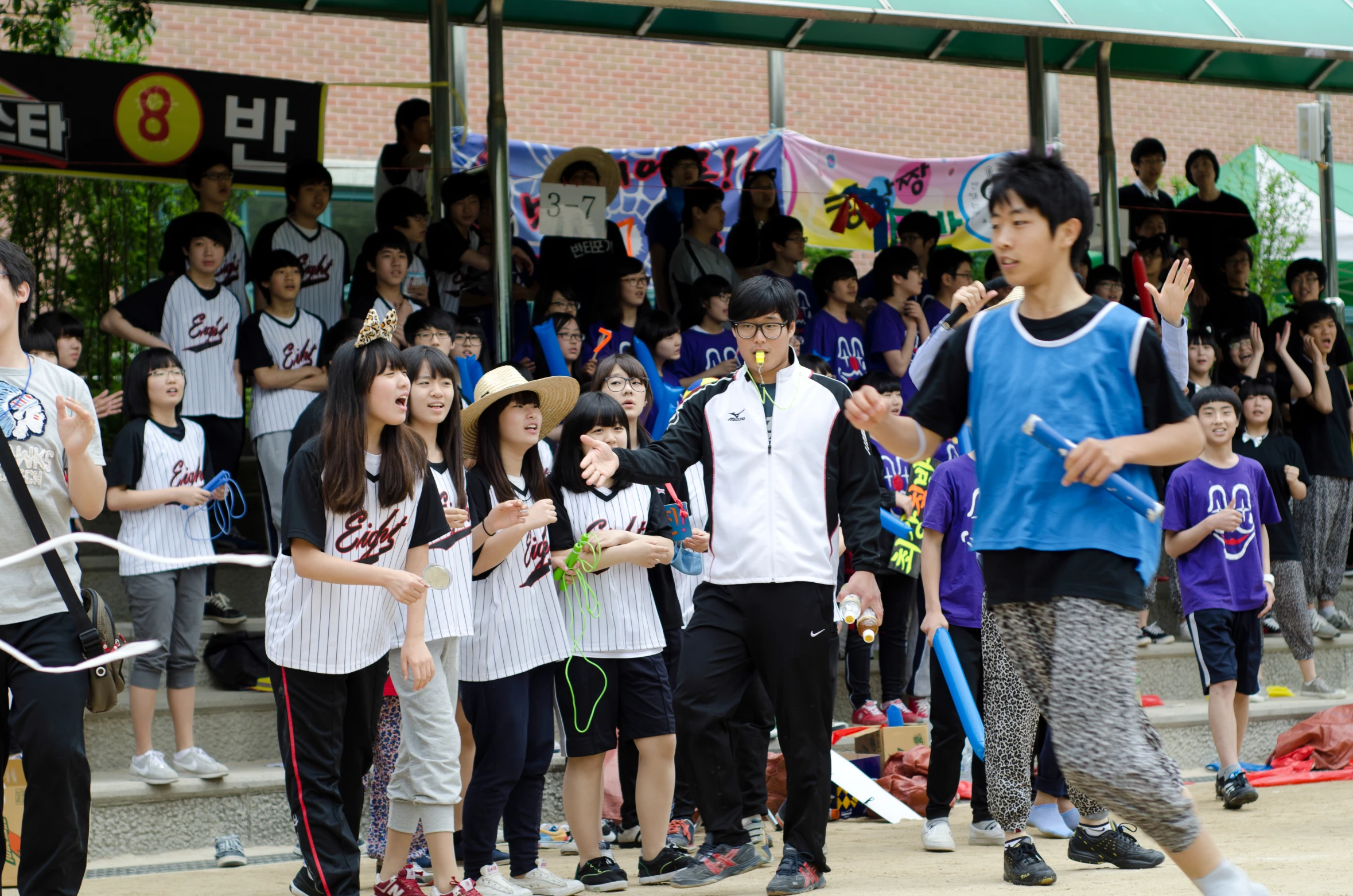 children are lined up watching the performers