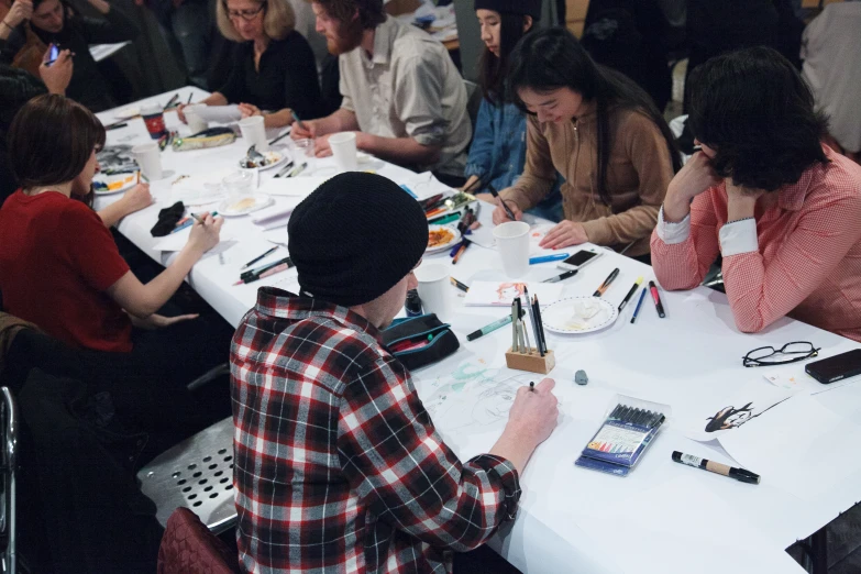 a group of people sitting around a table in a room