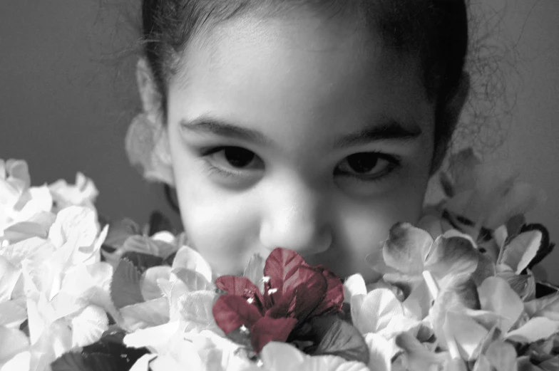 a black and white po of a girl's face and flowers