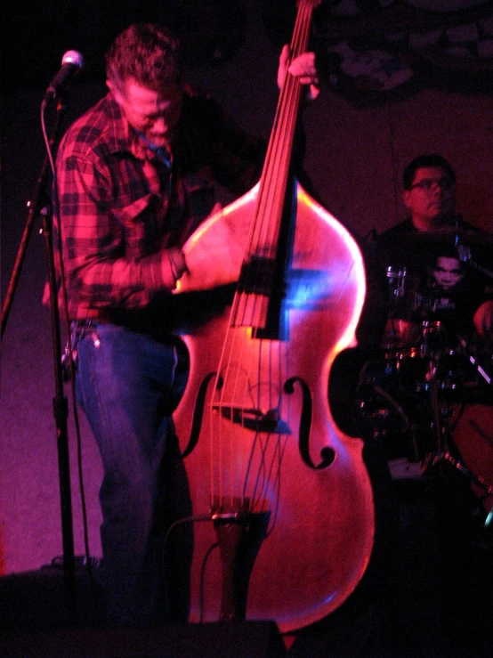 a man playing an electric violin on stage