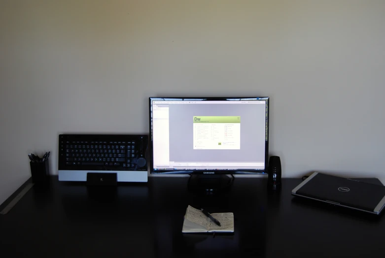 a monitor and keyboard on a computer desk