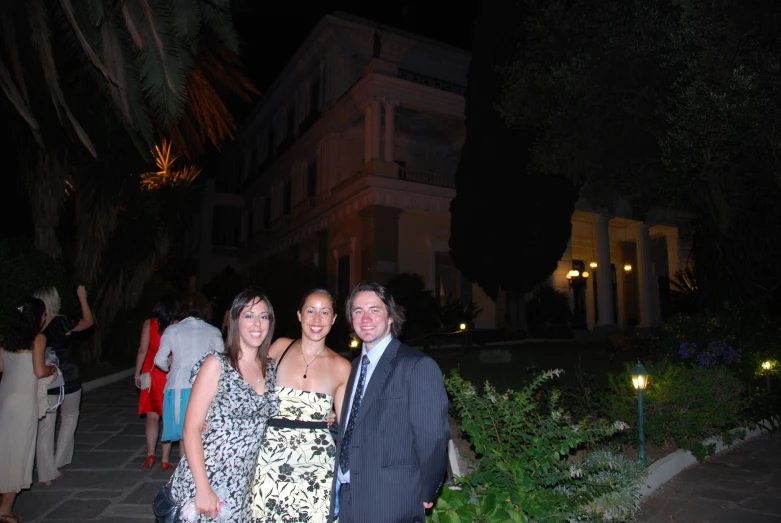 three people pose for a picture with their date on the night