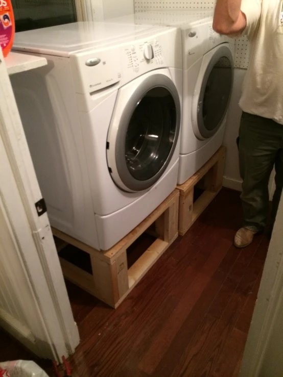 man putting two washers in a stack up area