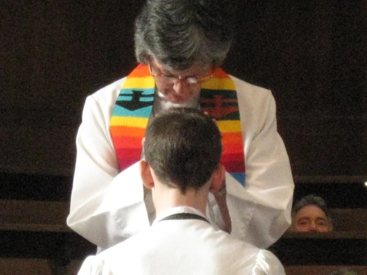 the person in white coat is standing near other people