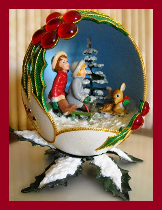 a small glass ornament is in the shape of a christmas scene