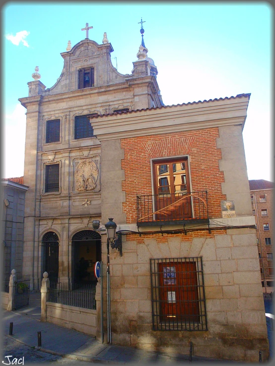 an old church with statues and iron gates