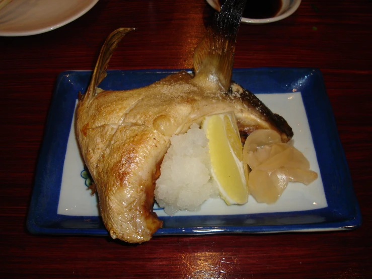 a plate with food on it sitting on a wooden table