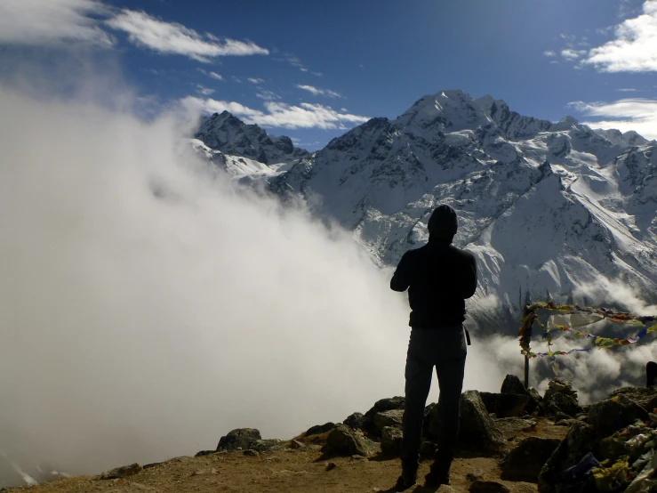 a man standing on top of a rocky cliff