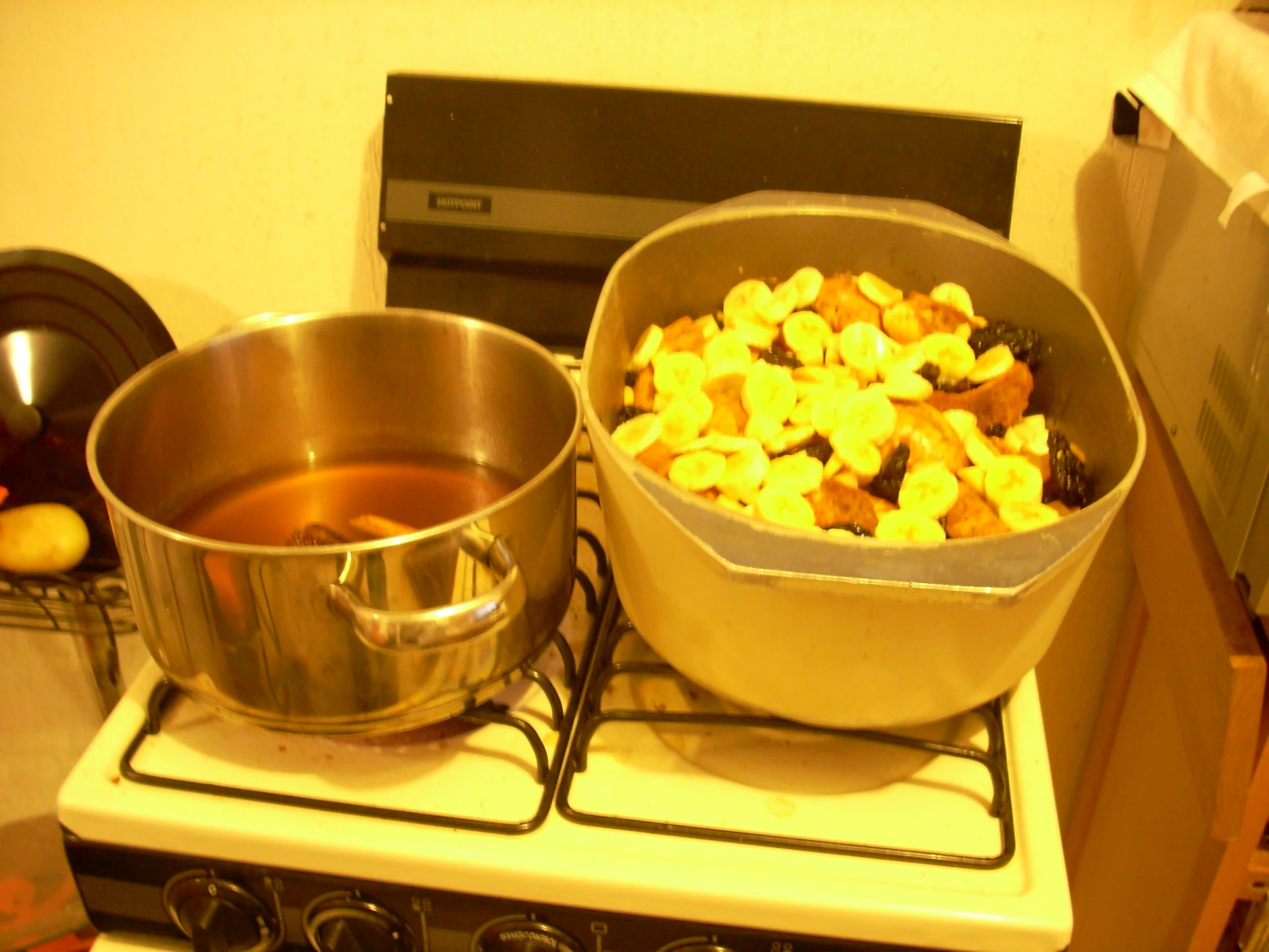 pots and pans on stove with food being prepared in kitchen