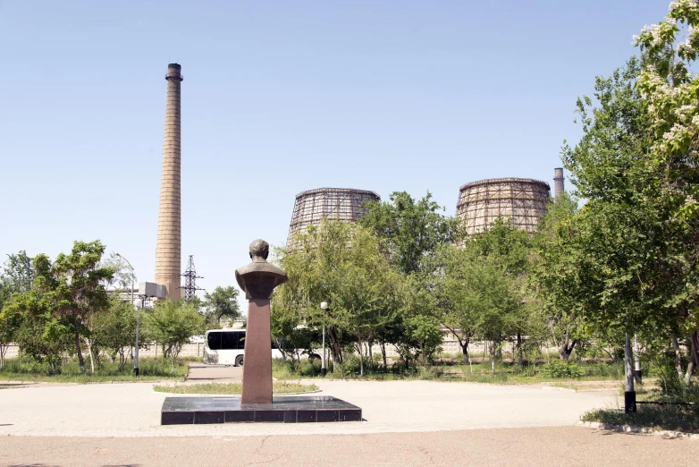 a tall brick building sitting on top of a dirt field