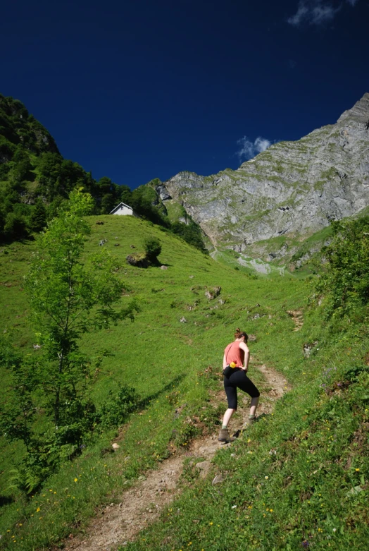 a man running up a hill in the wilderness