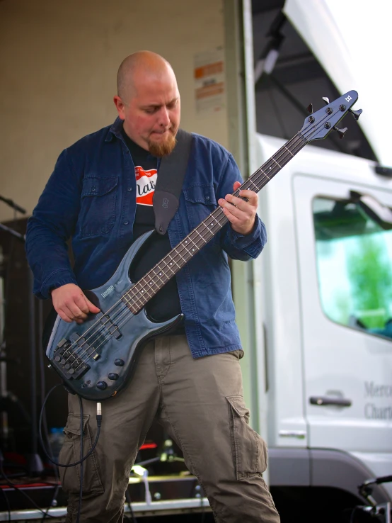 a man playing the bass guitar in a show