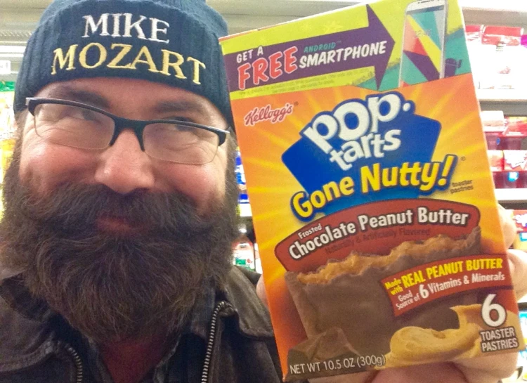 a man with a beard holding up a box of pop tarts