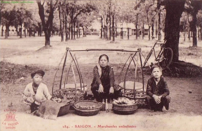 a group of children standing around some metal pots