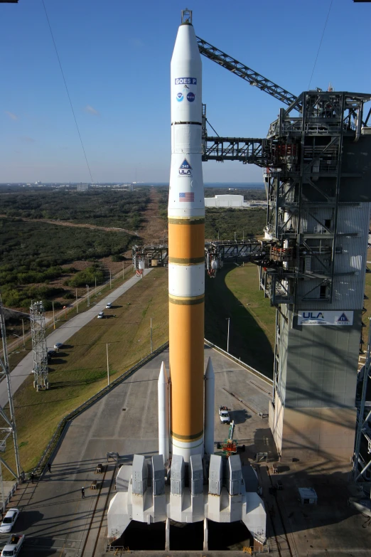 a saturn rocket on display in a field with the launch tower out of place