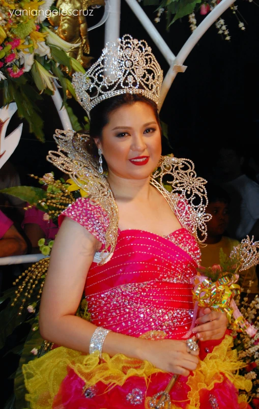 a beautiful young lady dressed in a red and yellow gown