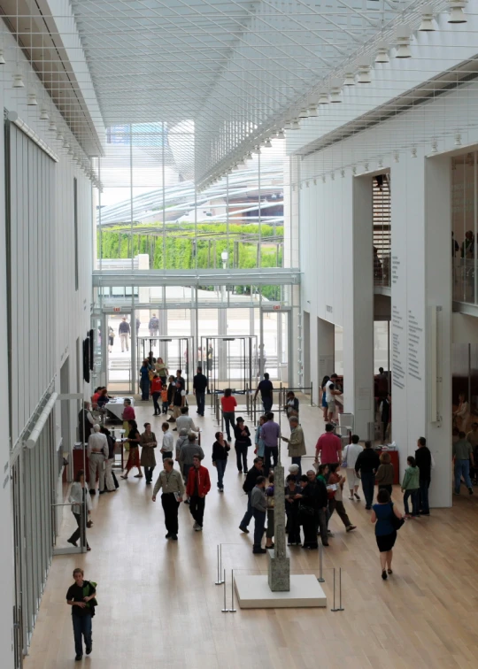 large group of people walking around inside a large building