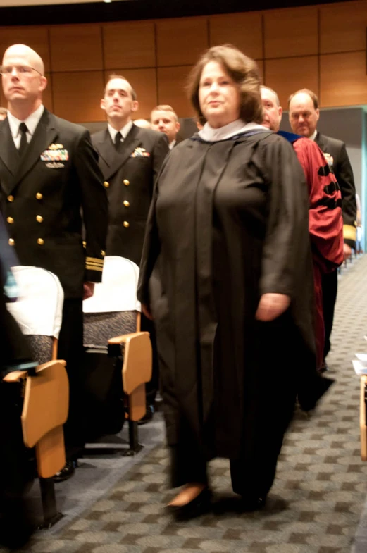 several military officers stand with a woman at the front