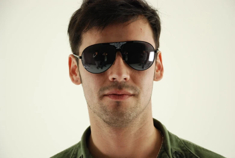 a young man wearing a pair of sunglasses