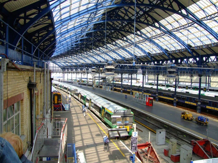 a view inside the train station looking at trains on tracks