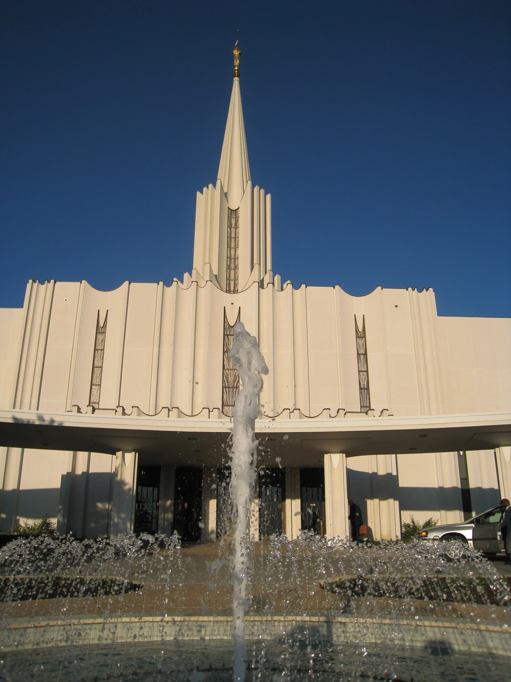 a building with a tall spire sitting over a fountain