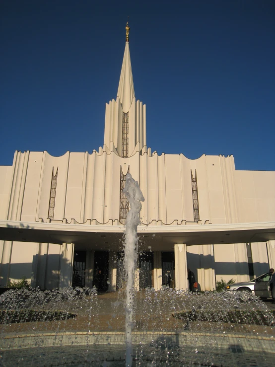 a building with a tall spire sitting over a fountain