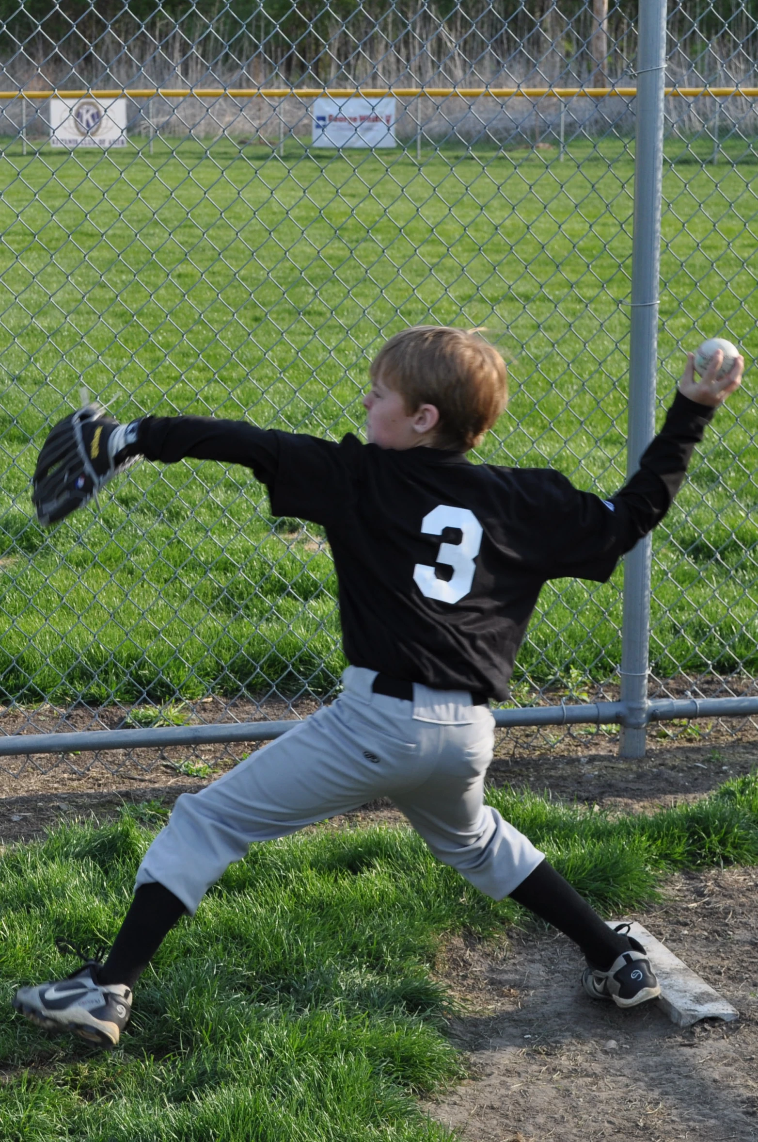 a baseball player with the number 3 on his uniform is in action