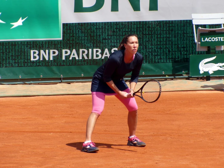 a female tennis player holding a tennis racquet on a court