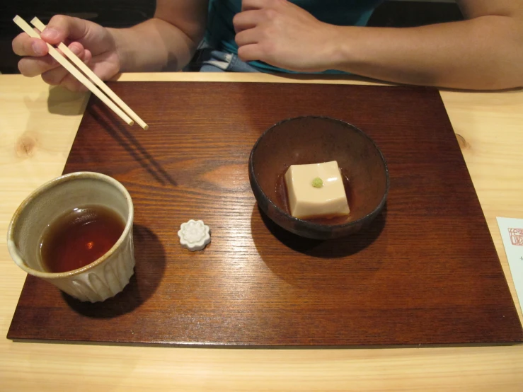 chopsticks and some food are in a bowl on a table