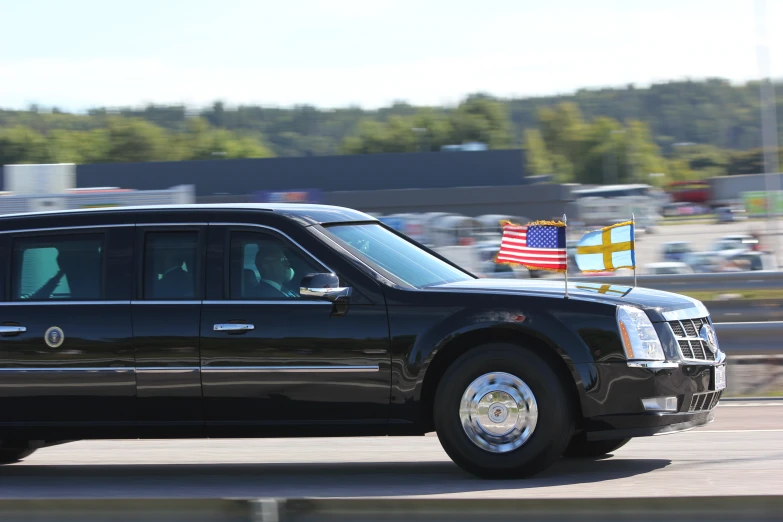 a black suv that is sitting on a road