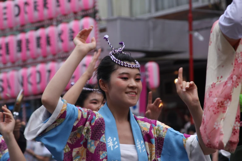 a woman in a traditional japanese costume performs at a parade