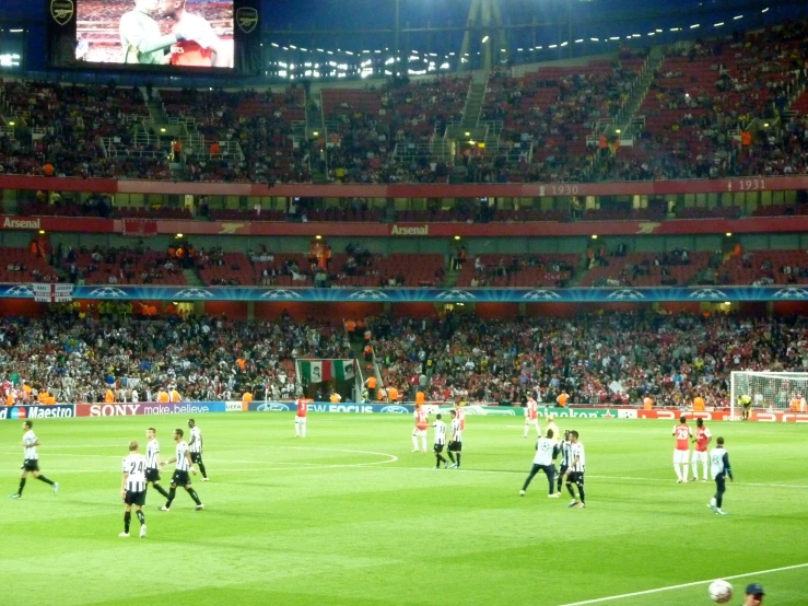 the team plays soccer at night on the field