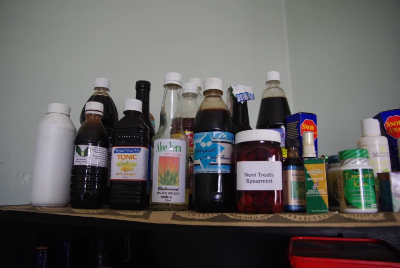 a shelf that has many bottles sitting on it