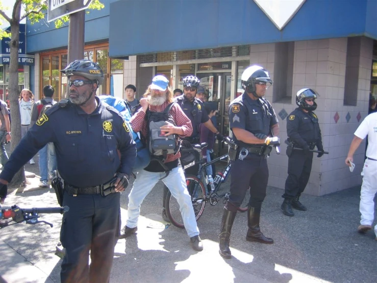 some police officers are walking on the side walk