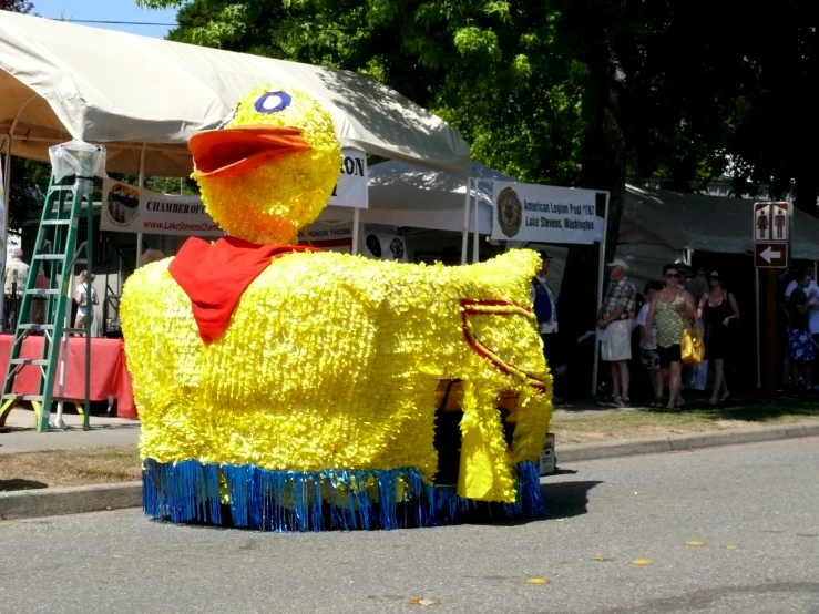 a giant yellow ducky float sits in a parade