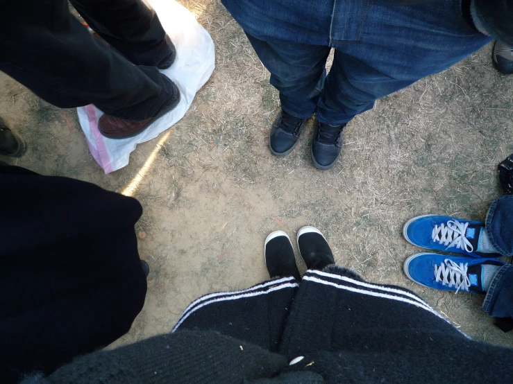 several people are standing in a group with their shoes on