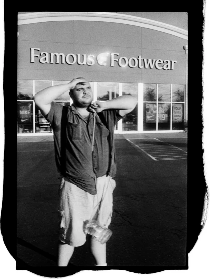 a man standing in front of a famous footwear store