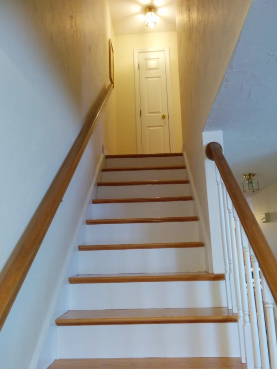 this stairway is well decorated with white wood