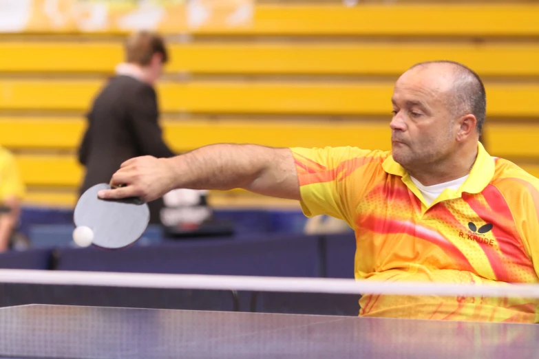 a man throwing a ping pong ball to a table