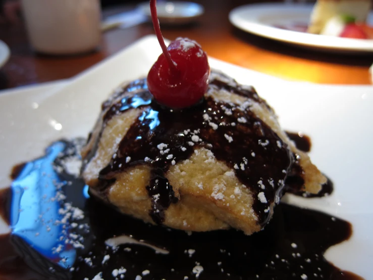 a dessert with chocolate, cream and ice cream on top