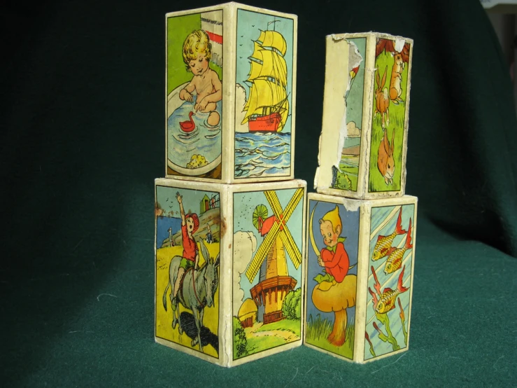 three wooden blocks decorated with pictures and a teddy bear