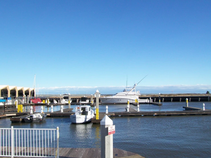 several boats docked at a pier in the water